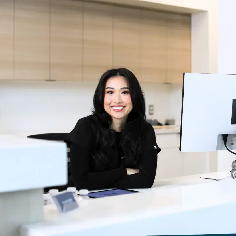 Smiling team member at Fusion Dental Implants